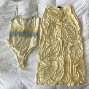 Two piece satin corset bodysuit and midi skirt set.